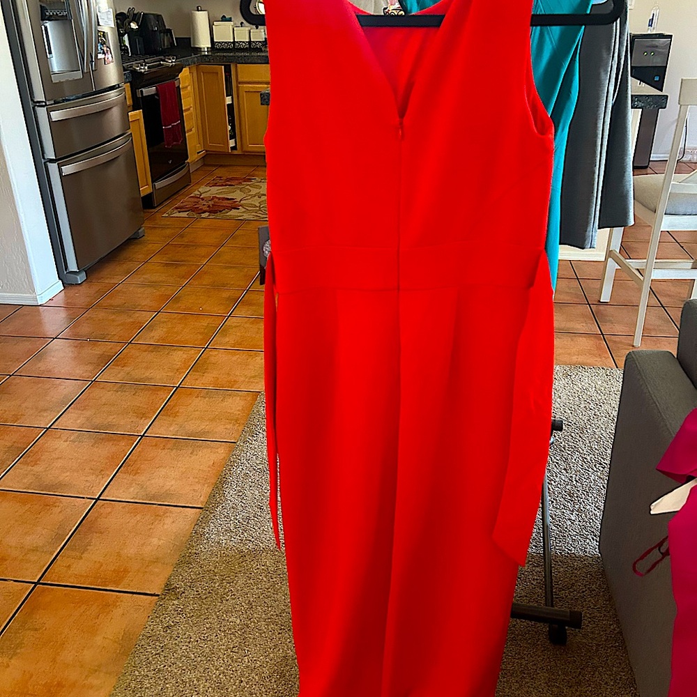 New jumpsuit, wide leg, gold zipper in the back and extra button. Buttons up.